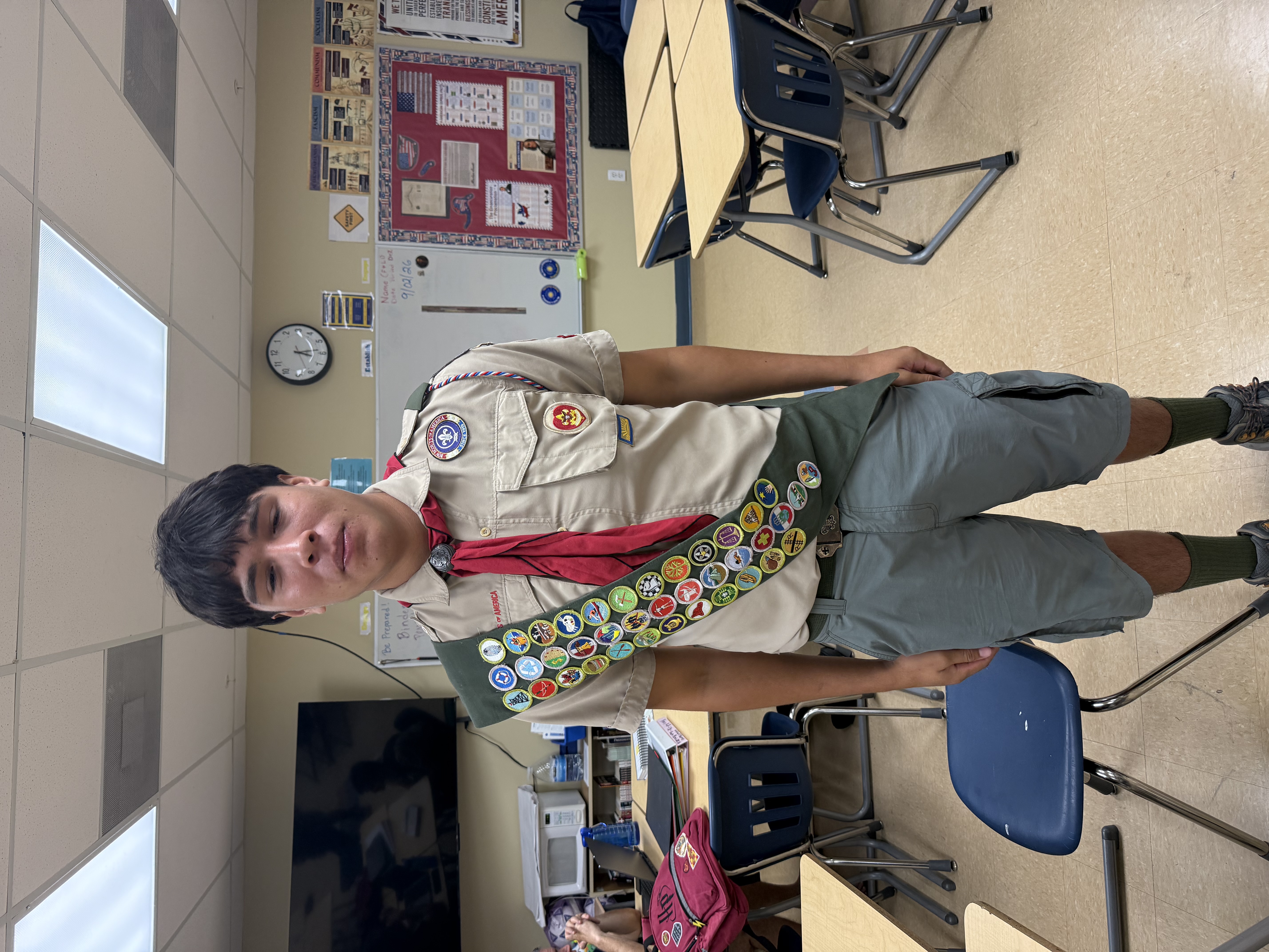 Jack Cavanagh in his Scout uniform wearing his merit badge sash